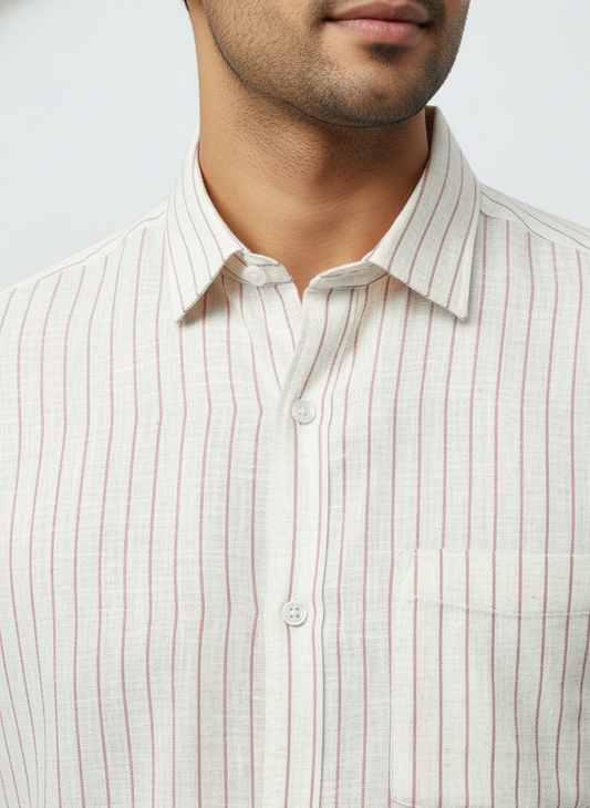 Close-up of a man wearing white and red striped shirt against a white background