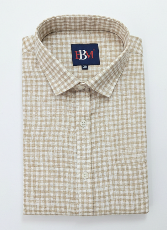 Folded checkered shirt with a brand label on a white background