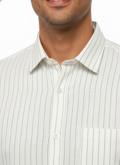 Close-up of a man wearing a light-colored striped shirt with a white background