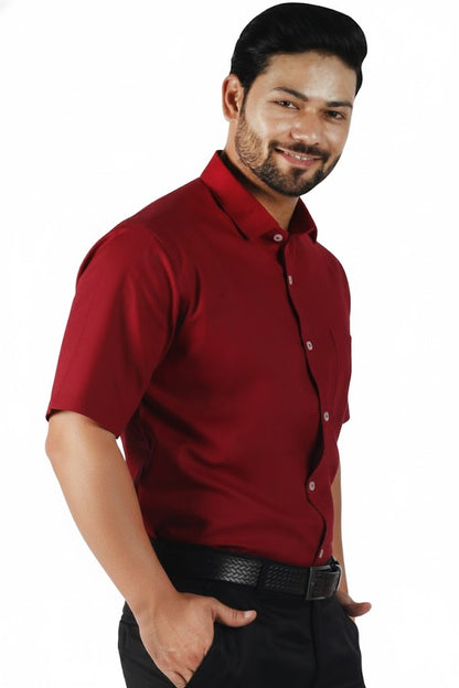 Man wearing a red shirt and black pants on a white background